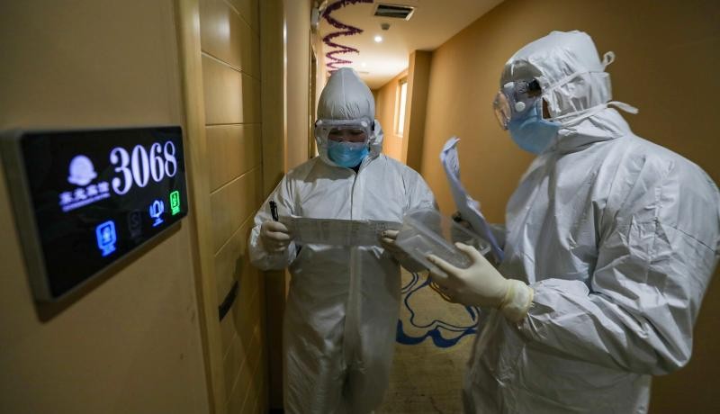 Medical staff on their rounds at a quarantine zone in Wuhan, China. Photo by STR/AFP via Getty Images. 