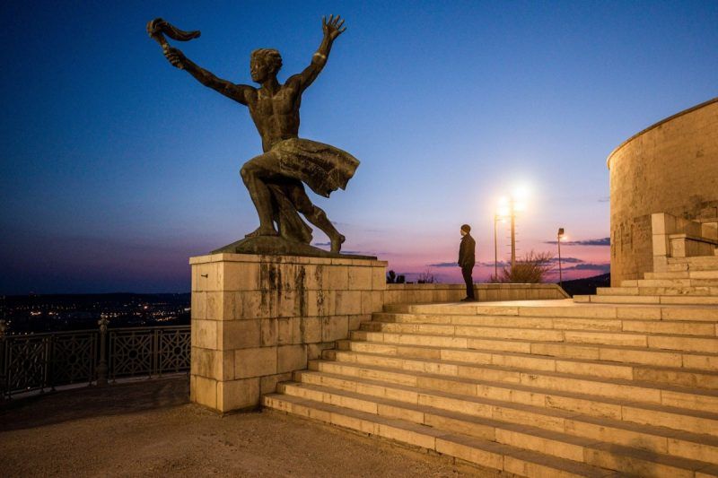 A pedestrian takes in the view from the stairs of the deserted Citadel at night in Budapest on March 31. Hungary's parliament handed Prime Minister Viktor Orban the right to rule by decree indefinitely, effectively putting the country under his sole command. (Akos Stiller/Bloomberg)