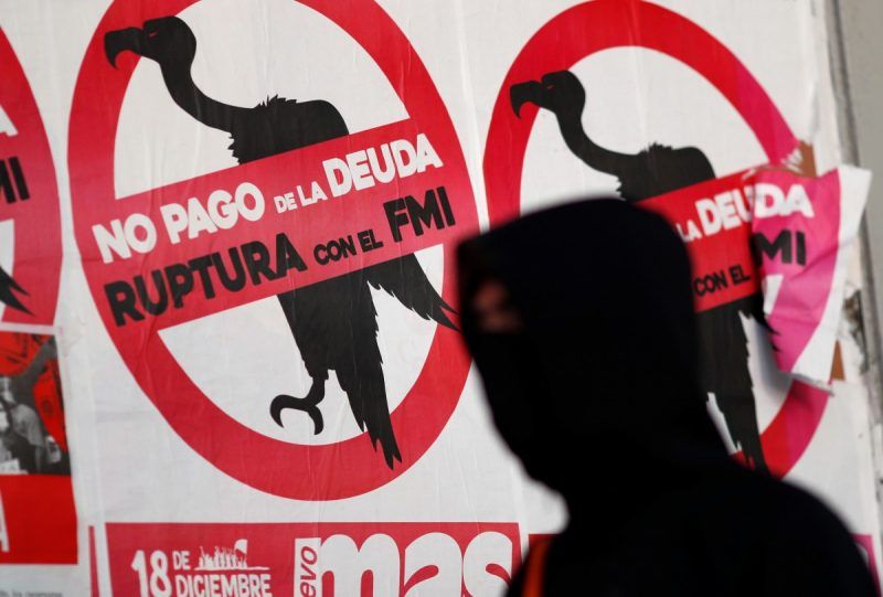 A pedestrian walks past posters on the street that read “No to the payment of the debt. Break with the IMF”, in Buenos Aires on Wednesday. (Agustin Marcarian/Reuters)