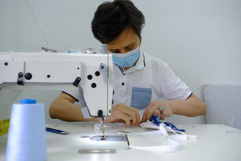 A worker making protective masks at a production facility in Kuala Lumpur, Malaysia. (Samsul Said/Bloomberg)