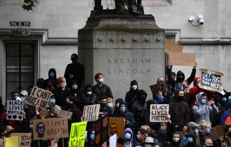 Daniel Leal-Olivas/AFP via Getty Images. Anti-racism protesters around a statue of Abraham Lincoln in Parliament Square, London, England, June 6, 2020
