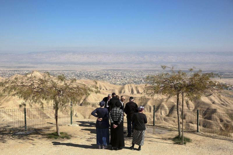 People gather in the Jewish settlement of Mitzpe Yeriho overlooking the West Bank city of Jericho on Jan. 26. (Oded Balilty/AP)