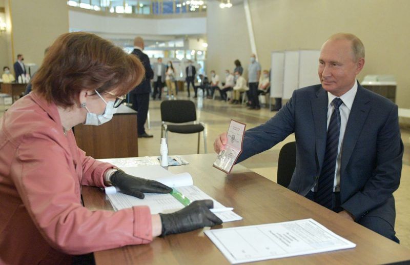 Alexei Druzhinin/TASS via Getty Images. President Putin presenting his identification document to validate his vote in Russia’s constitutional amendment referendum that would permit him to remain president until 2036, Moscow, July 1, 2020
