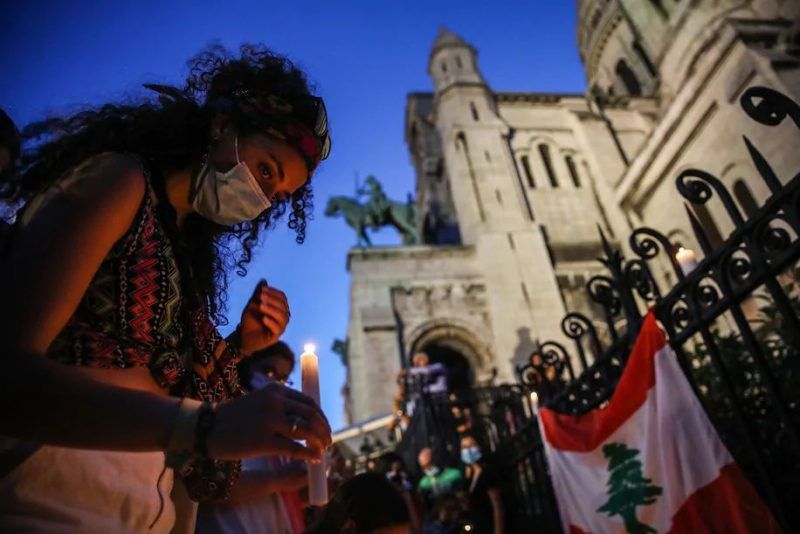People light candles during the Solidarity Stand event, held to show solidarity with the victims of blasts in Beirut, next to the Basilica of the Sacred Heart in Paris on Wednesday. (Mohammed Badra/EPA-EFE/REX/Shutterstock)