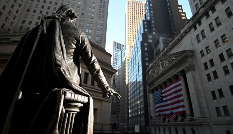 A statue of George Washington is pictured in front of the New York Stock Exchange (NYSE) on 16 March 2020, at Wall Street in New York City. Photo by JOHANNES EISELE/AFP via Getty Images. 
