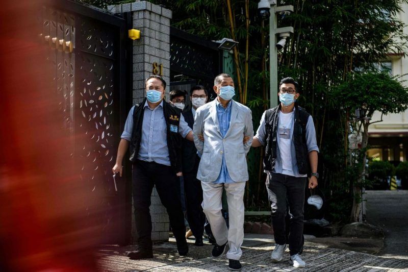Jimmy Lai, a Hong Kong pro-democracy media mogul, was led away from his home Monday after his arrest under the new national security law. Credit Vernon Yuen/Agence France-Presse — Getty Images