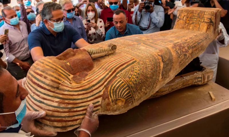 The Egyptian minister of tourism and antiquities, Khaled Al-Anani (wearing glasses), opens a sarcophagus excavated this month by the Egyptian archaeological mission working at the Saqqara necropolis. Photograph: Khaled Desouki/AFP/Getty Images