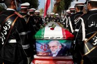 Members of Iranian forces carry the coffin of Iranian nuclear scientist Mohsen Fakhrizadeh during a funeral ceremony in Tehran on Nov. 30. (Iranian Defense Ministry/WANA/Reuters)