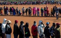 People line up at a food distribution site in Pretoria, South Africa, on May 20. (Themba Hadebe/AP)
