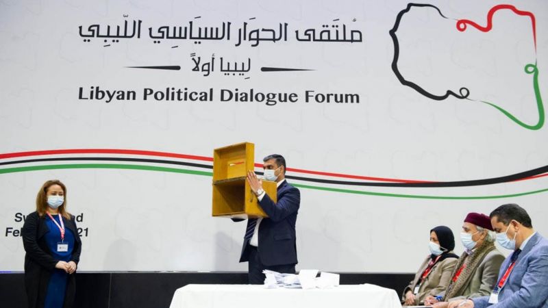 A UN official shows the ballot box to participants of the UN-hosted Libyan Political Dialogue Forum in Geneva, 5 February 2021. UNSMIL