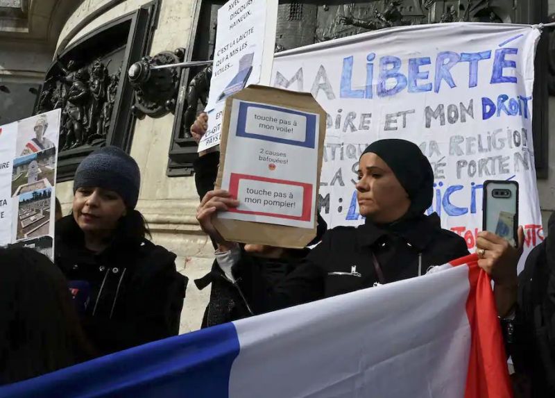 Women hold signs reading "Don't touch my headscarf" as they demonstrate Oct. 19, 2019, on the Place de la Republique in Paris. (DOMINIQUE FAGET/AFP via Getty Images)