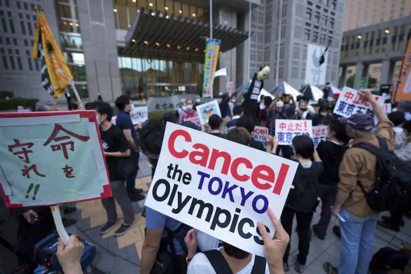 People against the July opening of the Tokyo 2020 Olympics, gather to protest around the Tokyo Metropolitan Government building during a demonstration on June 23. (Eugene Hoshiko/AP)