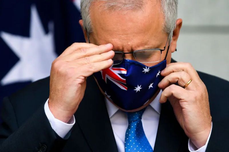 Australian Prime Minister Scott Morrison removes his mask before speaking at a conference following a national cabinet meeting, at Parliament House in Canberra, Australia on July 2. (Lukas Coch/EPA-EFE/REX/Shutterstock)