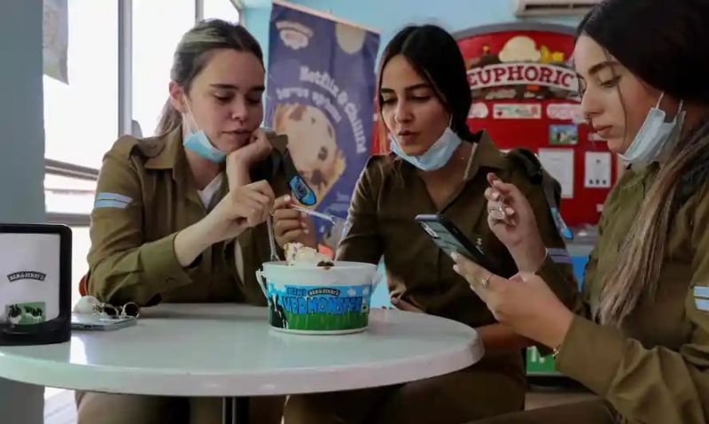 Israeli soldiers eat at the Ben & Jerry’s factory in Be’er Tuvia on Wednesday. Photograph: Emmanuel Dunand/AFP/Getty Images