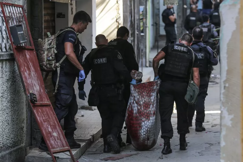 Police carry the body of one of the 28 people killed during a police operation in the Jacarezinho favela of Rio de Janeiro on May 6. Credit Andre Coelho/EPA, via Shutterstock