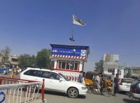 A Taliban flag flies in the main square of Kunduz, Afghanistan, after fighting between Taliban and Afghan security forces on Aug. 8. (Abdullah Sahil/AP)