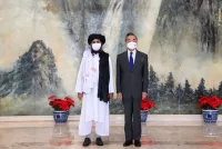 The Taliban co-founder Mullah Abdul Ghani Baradar, left, and China’s foreign minister, Wang Yi, in July. Li Ran/Xinhua, via Associated Press