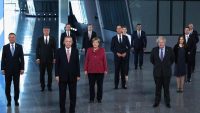 Turkey's President Recep Tayyip Erdogan (3rd L) looks on next to German Chancellor Angela Merkel (C) and Britain's Prime Minister Boris Johnson (R) as NATO Heads of the states and governments pose for a family photo prior to a NATO summit. YVES HERMAN / POOL / AFP