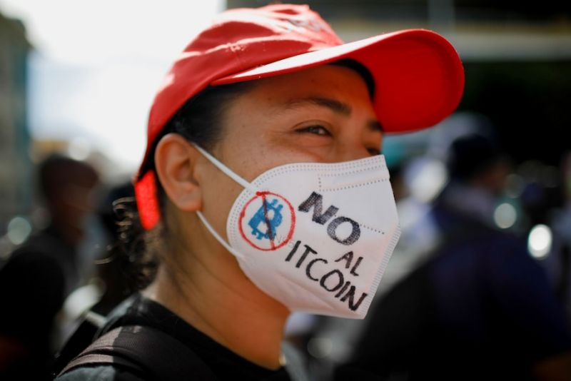 A woman takes part in a protest against the use of bitcoin as legal tender in San Salvador on Sept. 7. (Jose Cabezas/Reuters)