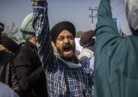 Sikh community members shout slogans during the funeral of Supinder Kaur, a slain school principal, on Oct. 8 in Srinagar, India. (Mukhtar Khan/AP)