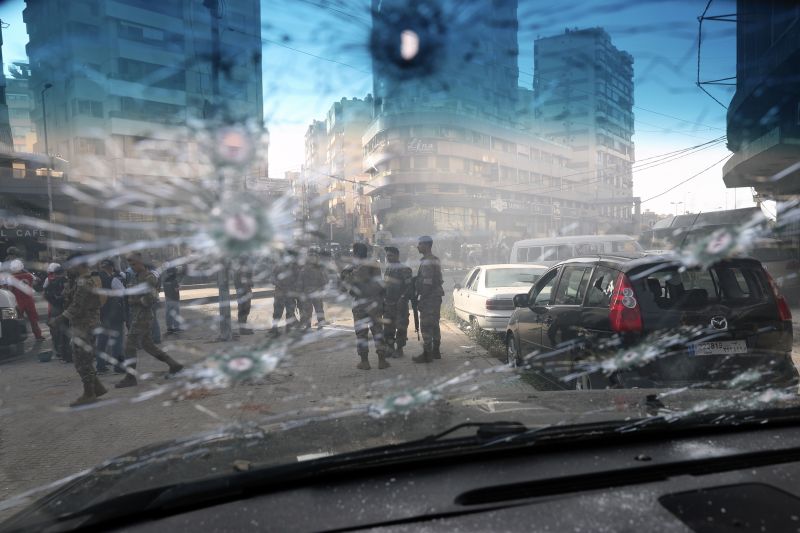 Lebanese army soldiers are seen through the bullet-riddled window of a car after deadly clashes erupted in Beirut on Oct. 14. (Bilal Hussein/AP)