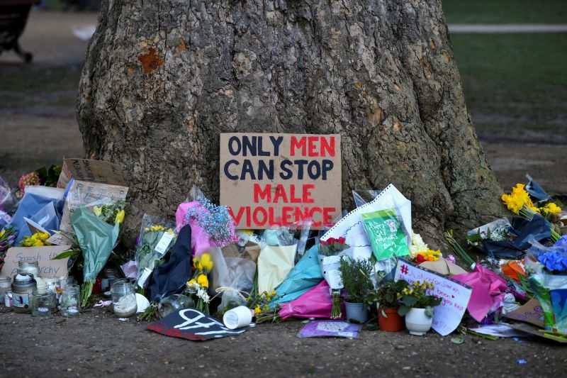 Signs and flowers near the Clapham Common Bandstand in London on March 17, after the kidnap and murder of Sarah Everard by a Metropolitan Police officer. (Dylan Martinez/Reuters)