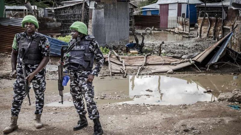 Two Nigerian Policemen deployed in Somalia as part of the African Union peacekeeping mission patrol next to an area destructed by heavy rains and floods in Beledweyne, Somalia, on December 14, 2019. LUIS TATO / AFP