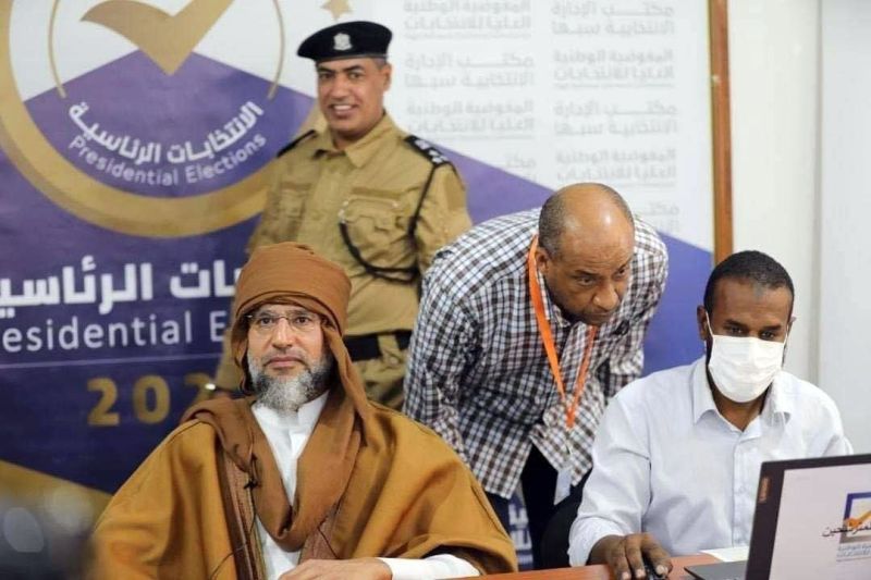 Saif al-Islam Gaddafi, left, son of the former Libyan leader Moammar Gaddafi, registers to run in upcoming presidential elections in Sebha, south of Tripoli, Libya. (Libyan Electoral Commission Handout/EPA-EFE/REX/Shutterstock)