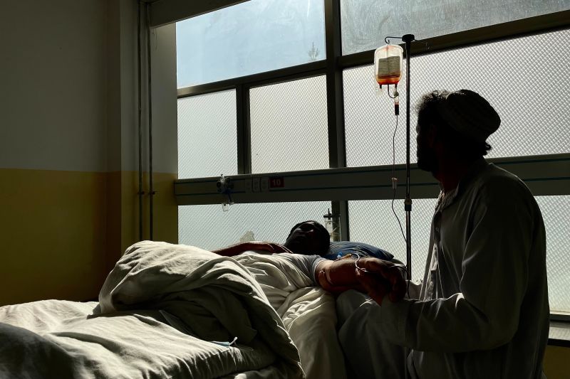 A nurse attends to a patient in the emergency ward of Kabul's Jumhuriat Hospital, which has run out of critical supplies such as dressings and insulin after the halt in aid to Afghanistan. (Susannah George/The Washington Post)
