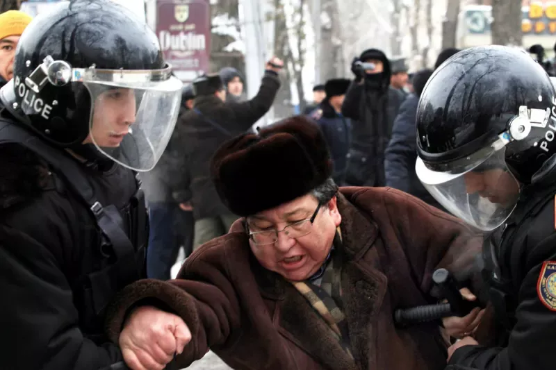 Riot police detain an opposition supporter during a rally in Almaty in 2011, when oil workers also went on strike demanding better pay and conditions © Anatoly Ustinenko/AFP via Getty Images