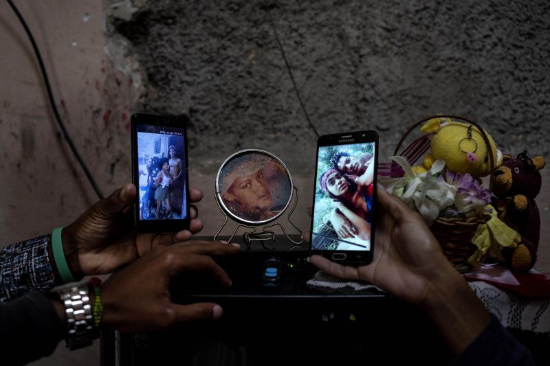People in Havana show photos of relatives imprisoned for participating in anti-government protests last year. (Ramon Espinosa/AP)