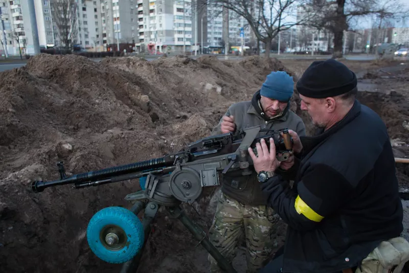 Members of a Ukrainian territorial defense battalion set up a machine gun on Feb. 25, in Kyiv. (Anastasia Vlasova/Getty Images)