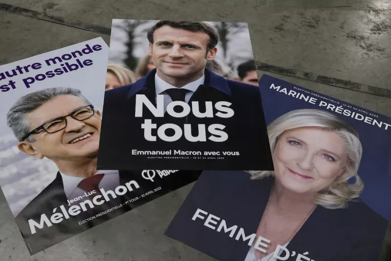 Campaign posters of French President Emmanuel Macron, Marine Le Pen and Jean-Luc Mélenchon are displayed at France Affichage Plus dispatch hub in Mitry-Mory, outside Paris, on March 22. (Benoit Tessier/Reuters)