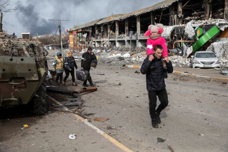 Families flee the Ukrainian city of Bucha along a war-torn main road in Irpin, Ukraine, on March 12. (Heidi Levine for The Washington Post)