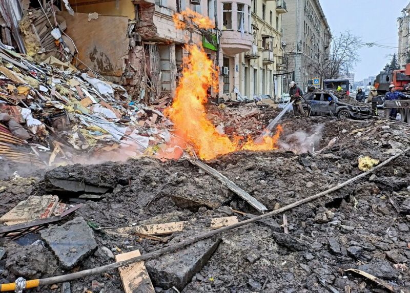 Rescuers work next to a building damaged by a Russian airstrike in Kharkiv, Ukraine, on March 14. (Vitalii Hnidyi/Reuters) 