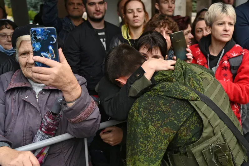  A woman says goodbye to a recently drafted man in Bataysk, Russia, September 2022. Sergey Pivovarov / Reuters