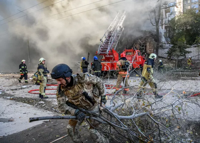 Firefighters help evacuate a residential building destroyed by a Russian drone strike in Kyiv on Oct. 17. (Vladyslav Musiienko/Reuters) 