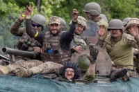 Ukrainian service members riding through the Donetsk region, Ukraine, May 2022. Carlos Barria / Reuters.