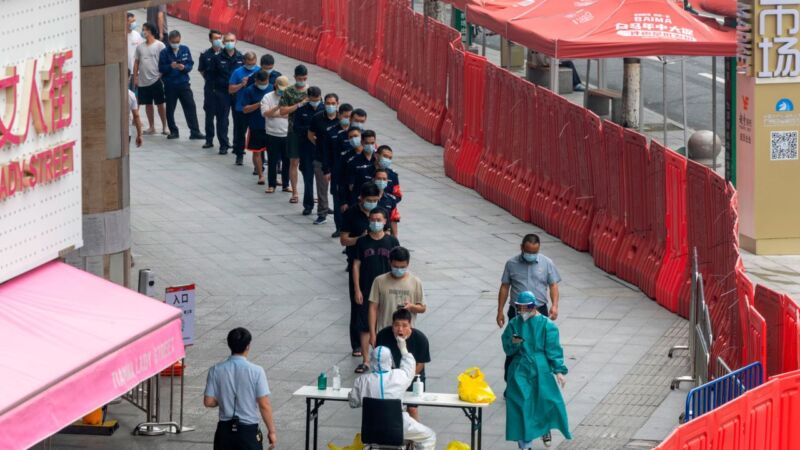 People line up last week for Covid-19 screening in a market enclosed by a temporary wall in Guangzhou, China. Julien Tan/FeatureChina/AP