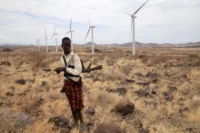 A Turkana herdboy near wind turbines in Loiyangalani district, Kenya, September 2018. Thomas Mukoya / Reuters