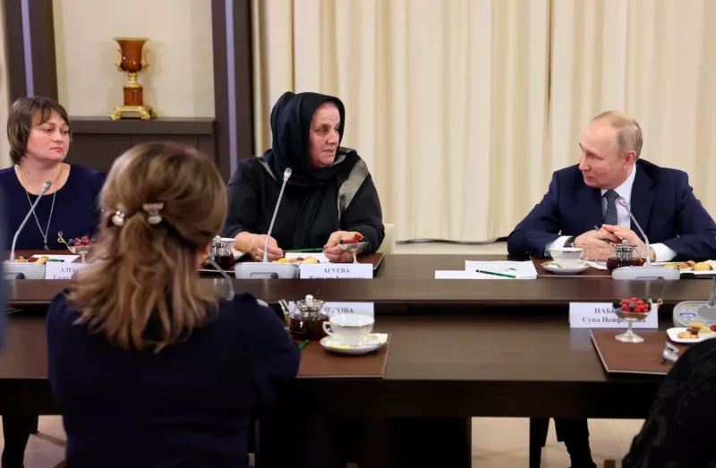 Putin listens to Zharadat Agueva of Chechnya as Elena Alekseeva of Stary Oskol, Russia, sits at left, during a meeting with mothers of soldiers fighting in Ukraine. (Mikhail Metzel, Sputnik, Kremlin Pool Photo via AP)