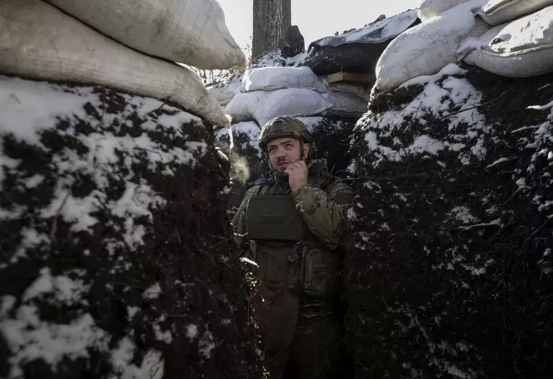A Ukrainian soldier stands in a trench at a front line in the Donetsk region of Ukraine on Jan. 7. (Anna Kudriavtseva/Reuters) 