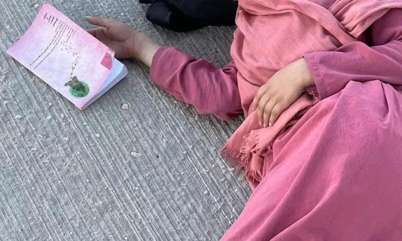 One of Shabana Basij-Rasikh’s new students asleep on an airport floor, with a novel beside her. (Shabana Basij-Rasikh) (Photo by Shabana Basij-Rasikh)