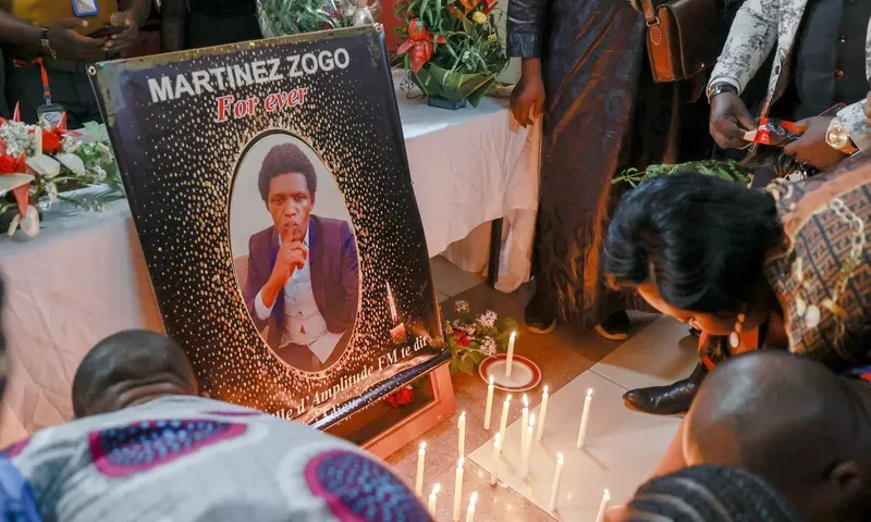 Mourners lay tributes during a ceremony for murdered journalist Martinez Zogo in Yaoundé in January. Photograph: Daniel Beloumou Olomo/AFP/Getty Images