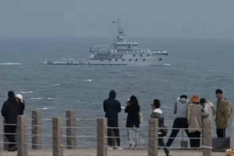 A Chinese navy vessel in the Taiwan Strait, as tourists look on from Pingtan Island. Military experts say Japan is underestimating the risk it would be involved if China were to invade Taiwan © Greg Baker/AFP/Getty Images