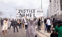 A protester holding placard saying ‘Justice for Nahel’ during a march in Nanterre, Paris, 29 June 2023. Photograph: Telmo Pinto/Sopa Images/Shutterstock
