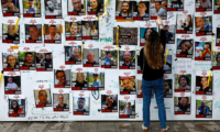 Posters of hostages on a wall in Tel Aviv, Israel, on 6 December. Photograph: Clodagh Kilcoyne/Reuters