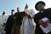 An Muslim imam, a Christian priest and two Jewish rabbis join a prayer calling for rain on November 11, 2010 in the West Bank village of Walajeh near Bethlehem. HAZEM BADER/AFP via Getty Images