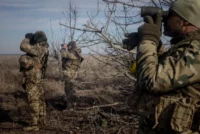 Members of Ukraine’s 72nd Brigade anti-air unit use binoculars to search for Russian drones near Marinka, Ukraine, on Feb. 23. Chris McGrath/Getty Images