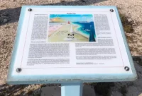The plaque next to the "slave huts" near the Oranje Pan, on the Dutch Bonaire island: a romanticized, incomplete and outdated account of the colonial past. Photo: Anne Van Mourik